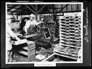 Three men cutting tile at the Simon's Brick Company