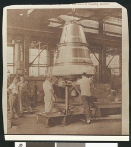 Several men inside the interior of an unidentified factory, ca.1930