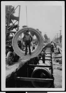 Workers installing storm drain pipe