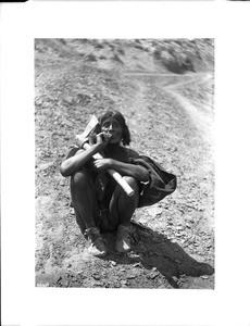 Hopi Indian farmer relaxing as he enjoys a cigarette, ca.1900