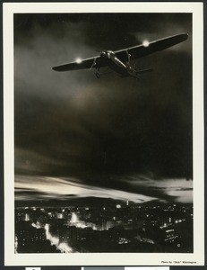 Composite (?) image "Wings of the Night", depicting a small commercial airliner flying at night over a city, ca.1935