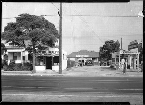 Medical and realty offices beside a small service station along South Central Avenue, Los Angeles, ca.1920
