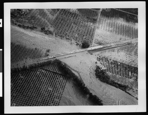 Aerial view of flooded Highway Number Ten bridge at the Santa Ana River, 1938