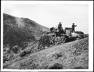 Four men at the Bucket & Windlass, a prospecting shaft, Hard Cash Mine, Randsburg, ca.1900