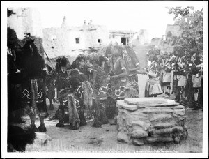 Hopi ("Moki") dancers throwing snakes into the circle of the sacred meal during the Snake Dance ceremony at Mishongnovi (Mashongnavi), Arizona, ca.1898