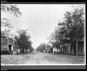 People standing near a street in Independence, ca.1886-1887