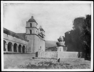 Mission Santa Barbara, California, with fountain and pepper trees, 1898