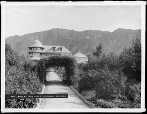 Exterior view of the Andrew McNally residence from a path and archway, Altadena, ca.1900