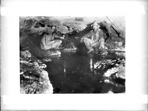 Two men at an outlet of Montezuma's Well, south side, near Camp Verde, Arizona, ca.1900