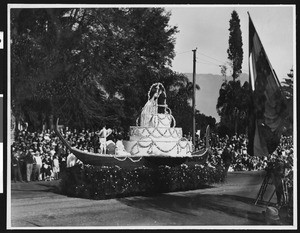 Motorized float at the Pasadena Tournament of Roses celebration shaped like a wedding cake, ca.1920