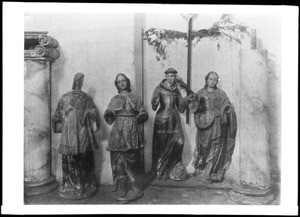 Four statues of saints needing repair at Mission San Juan Capistrano, ca.1900