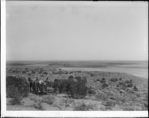 A man on a carriage looking over Old Palmdale from the foothills (and Mohave?), Palmdale, California, October 1897