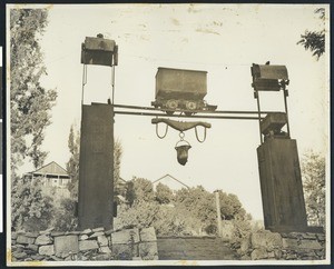 View of Angel's Camp in Utica Park, showing a mining cart suspended above the ground, ca.1930