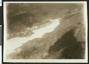 Aerial view of a reservoir above San Gabriel Dam Number One, Sawpit Dam, ca.1920