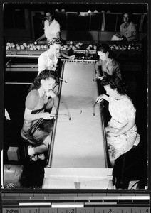 Interior of a citrus fruit packing house where women are inspecting fruit juice (?), ca.1930