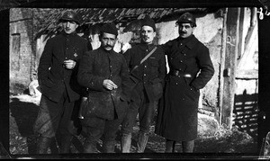 View of four soldiers smoking cigarettes in France during World War I, ca.1916