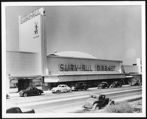 Exterior view of a Surv-All Market, showing a sign advertising Van de Kamps Bakery, ca.1941-1948
