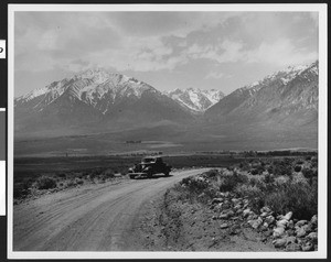 Automobile parked on the road to Owens River Gorge, showing the Owens Valley and Mount Tom in the background