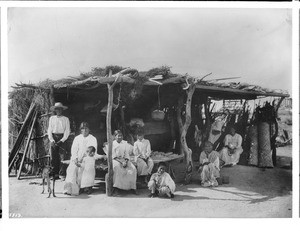 A group of 8 Yaqui Indians at their dwelling, Mexico, ca.1910