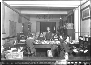 Seven women working in an unidentified stenographic and mailing room