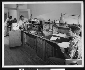 Workers inside an office at an unidentified electronics plant, ca.1940