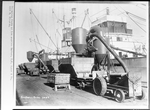 Machines unloading copra from a ship in Los Angeles Harbor