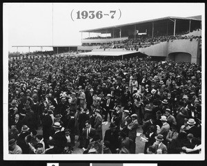 A spectators' area and a grand stand, possibly at santa Anita Racetrack, 1936-1937