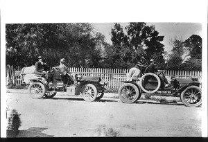 Portrait of two automobiles filled with motorists in front of the O.W. Childs residence on Twelfth Street west of Main Street, Los Angeles, ca.1904