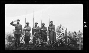 View of five soldiers standing near a French gravesite during World War I, ca.1916