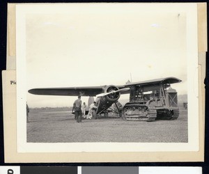 Tractor moving Amelia Earhart's airplane out of the mud in Oakland, January 23, 1935