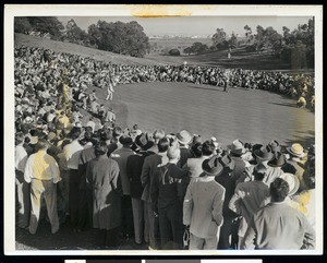 A golf tournament, showing people crowding around a golf course, ca.1920