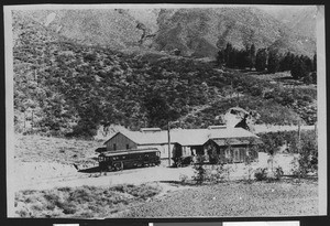 Trolley and automobile parked outside Arrowhead Water Company, Arrowhead Springs, ca.1914