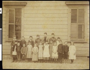 A group portrait of students and their teachers in front of La Dow School, ca.1900