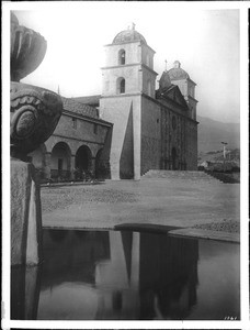 Mission Santa Barbara and reflection in the water of the Moorish fountain, 1901