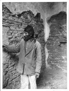 Sancristan at wall of Mission Tumacacori, Arizona, ca.1908