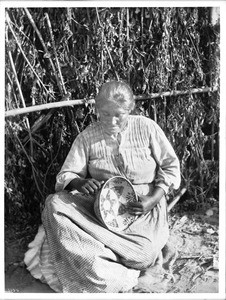 Coahuilla Indian woman making basket, Pala, ca.1905