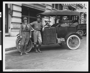 Man and woman, Eilerman, posed next to an automobile, ca.1928