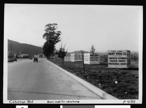 Large boxes advertising Sprigg Moving and Storage Company on the side of Cahuenga Boulevard, 1936