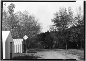 People standing in front of the entrance to the Eagle Nest Hunting Lodge on Catalina Island, January 14, 1928