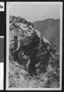 Men on a mountainside in front of a rock with crystals, ca.1930