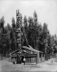 Totem pole of Haida Indians from Kitchikan, Alaska outside of a lodge in Portland, Oregon, ca.1900