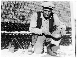 Man in front of a wall of bottles