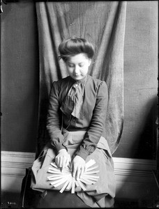 Indian woman demonstrating basket weaving, ca.1900