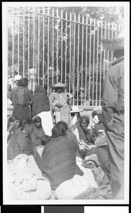 People sitting near a fence in Mexico, ca.1905