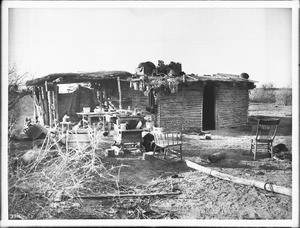 Native dwelling showing a Yuma Indian woman and child, ca.1900