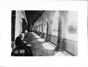 A Franciscan priest reading at Mission Santa Barbara, ca.1898-1900