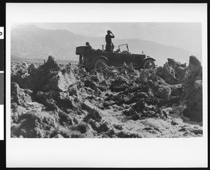 Men in an automobile by a salt marsh in the "Devil's Golf Course" area in Death Valley, 1922