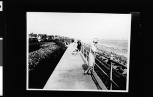 People on the promenade along the shoreline in Long Beach, 1929