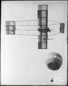 Louis Paulhan flying near a hot-air balloon in his Henry Farman biplane, Dominguez Field, Los Angeles, January 12, 1910