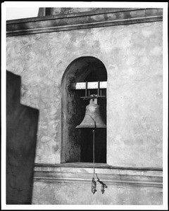 View of a cracked bell hanging in an unidentified church, 1900